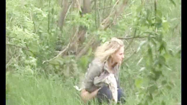 Blond with slender body is pissing outdoors