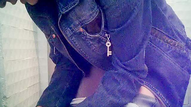 Cute babe in jeans is pissing