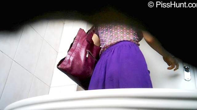 Horny babe is pissing in the toilet