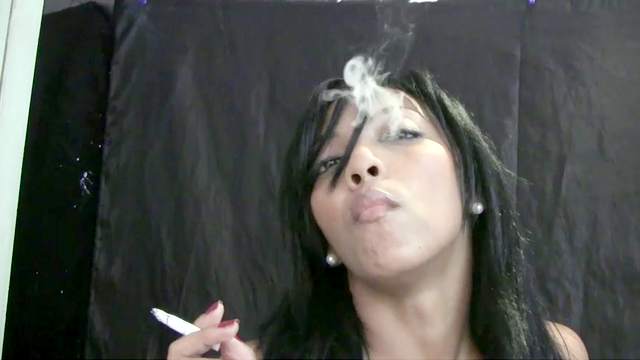 Dark-haired Latina poses and smokes