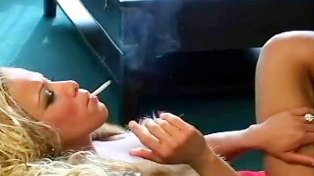 Curly blonde is smoking a cigarette