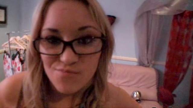 Blonde in glasses demonstrates her nice shaved pussy