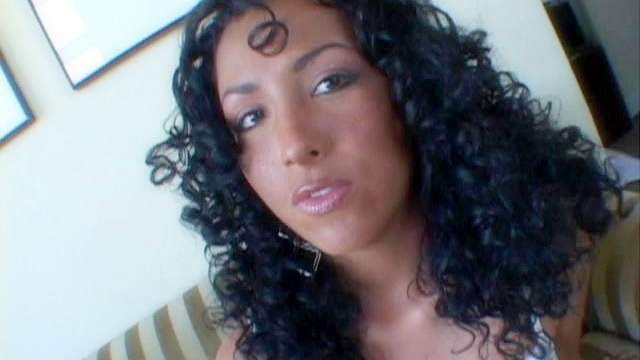 Curly-haired ebony is sucking white dick