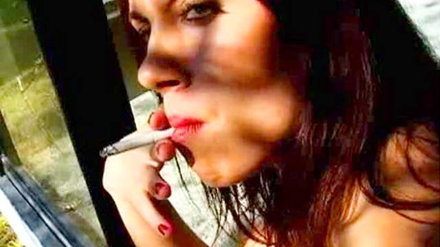 Brunette exhibits her big tits while smoking