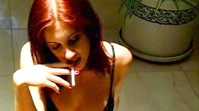 Spectacular redhead babe is smoking a cigarette