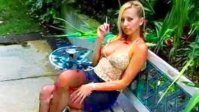 Blonde babe is smoking outdoors in fetish clip