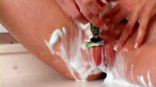 Soapy babe is shaving her lovely puss