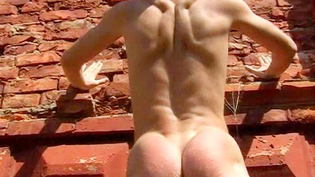 Muscular Leo being spanked outdoors