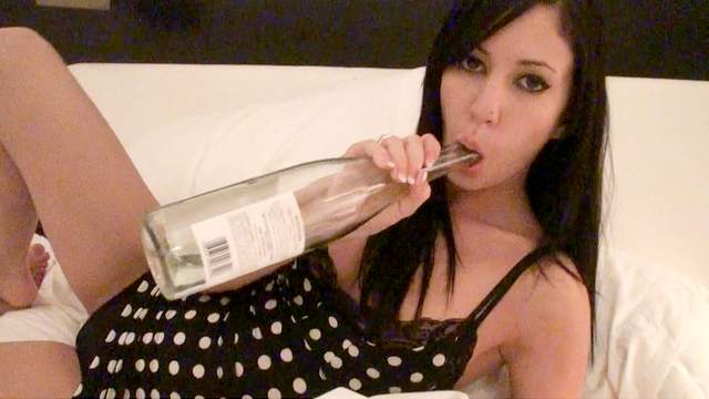 Catie Minx drinks from the bottle and stuffs her wet hole