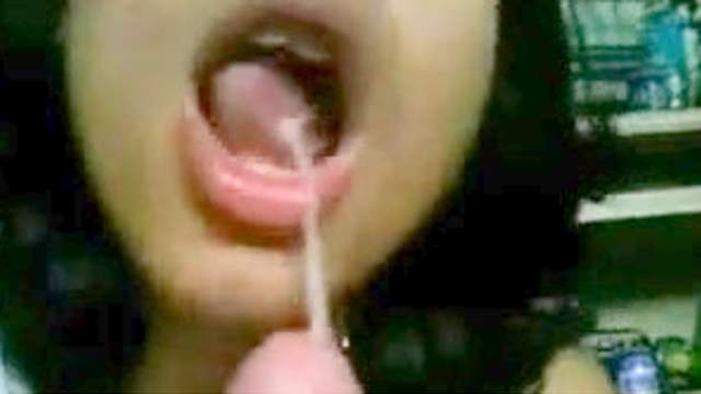Dark-haired cocksucker gets a cumshot in her mouth
