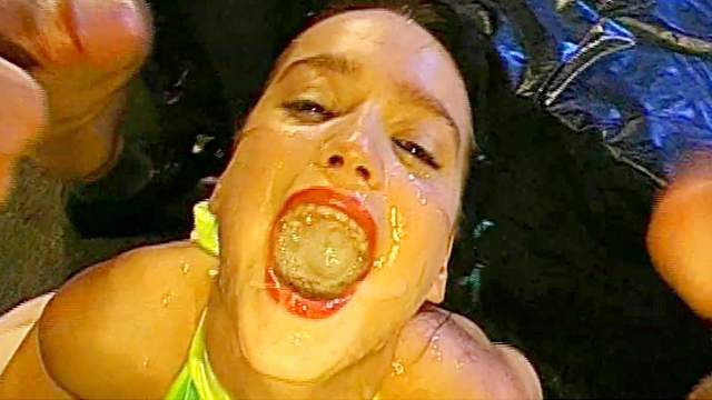 Brunette eats cum from a CD box and a spoon