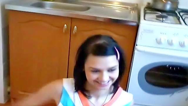 Russian brunette girl gets naked at the kitchen's floor