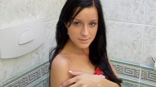 Dark-haired beauty is drilling herself with dildo