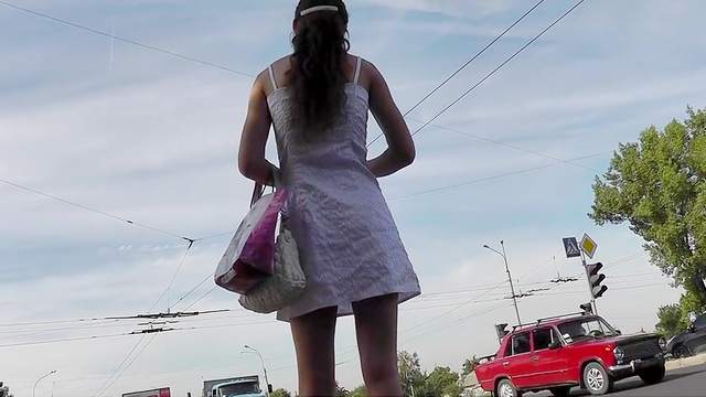 Young girl in sexy dress filmed outdoor upskirt