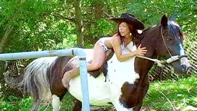 Mya is posing topless on the horse