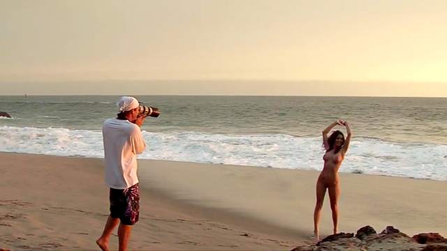 Sexy goddess is posing naked on the beach