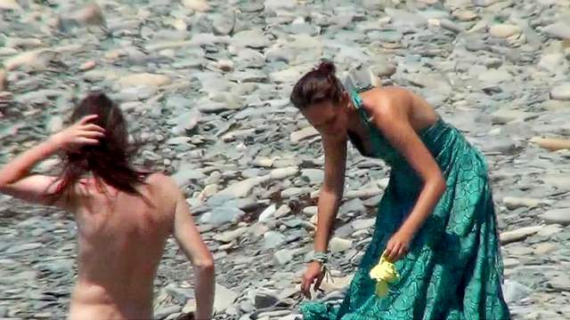 Sexy nudists are walking in the sea