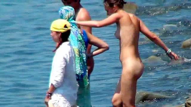 Sexy nudists are walking in the sea