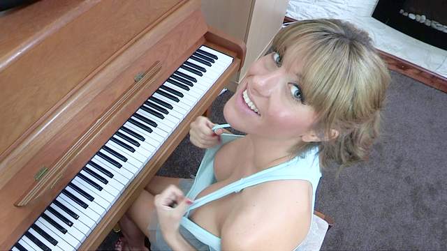 Sexy blonde Talia is playing on piano