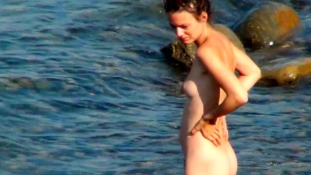Nudist is posing and playing with her boobies