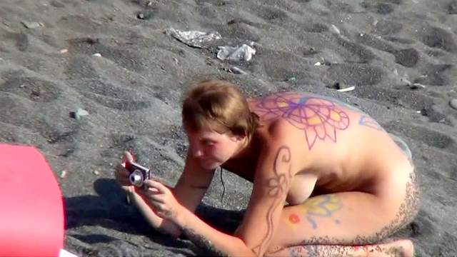 MILF nudist is getting naked on the beach