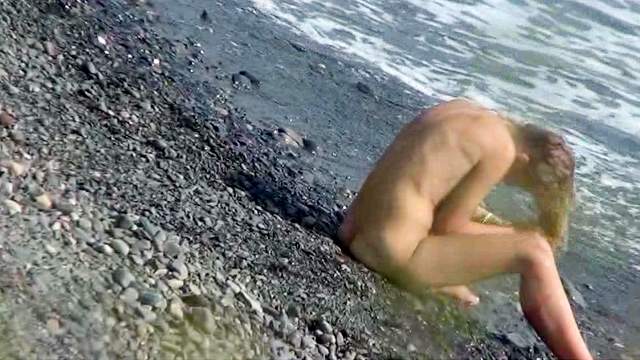Sweet lady is sitting in front water naked