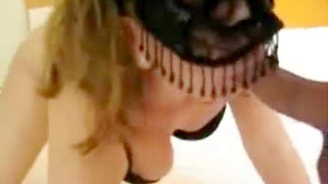 Beautiful masked wife polishes knob