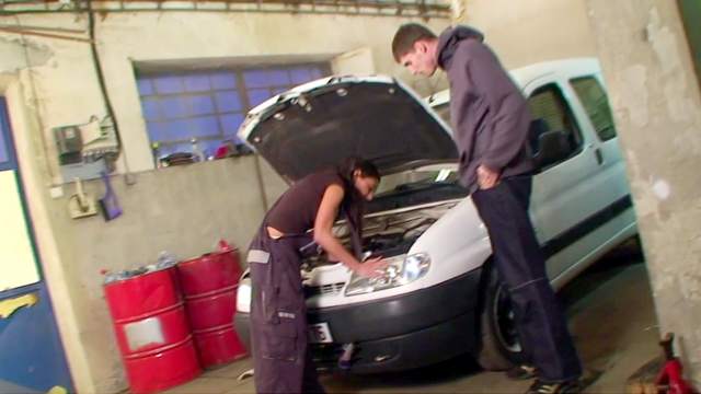 Gorgeous female mechanic gets busy in the garage she works at