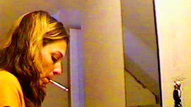 Sexy girl smokes in the mirror