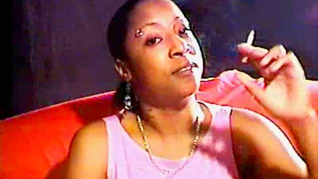 Pierced black girl smokes cigarette