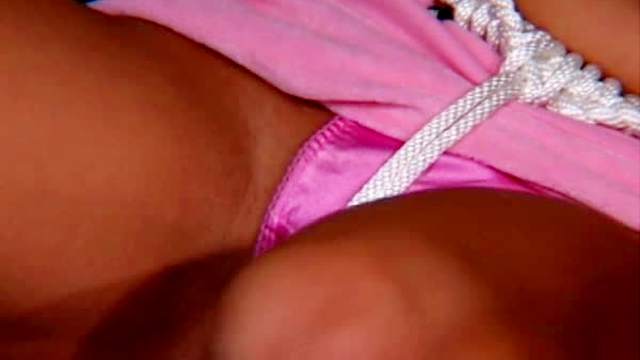 Busty girl bent in rope bondage positions