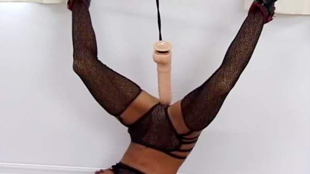 Gagged girl hangs upside down