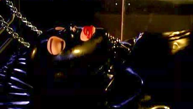 Sub girl encased in black rubber