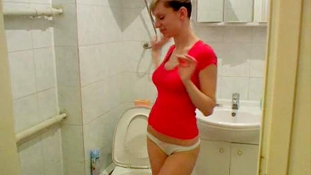Naughty and thin Olga is pissing in the toilet