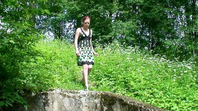 Redhead in a cute dress pisses outdoors