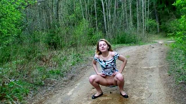 Sweet young girl goes pee outdoors