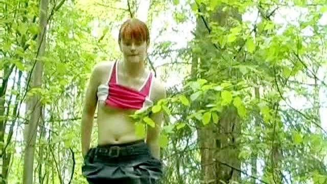 Redhead in short skirt pissing outdoors