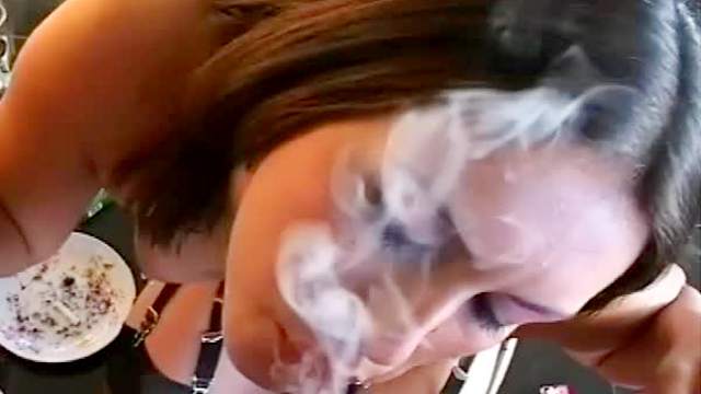 Incredible cock sucker is smoking and doing blowjob at the same time