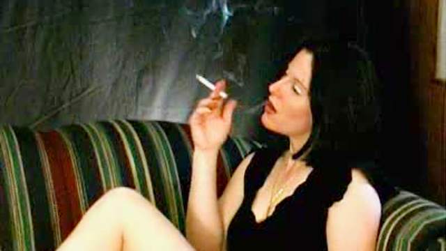 Pretty girl smokes cigarette sensually