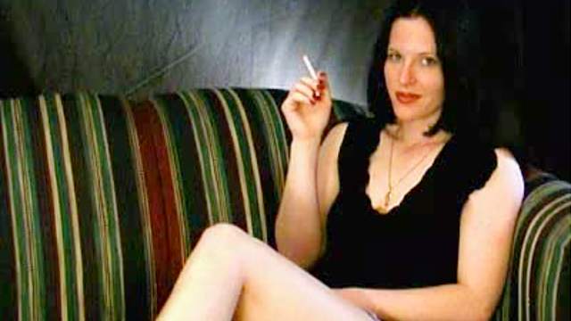 Pretty girl smokes cigarette sensually