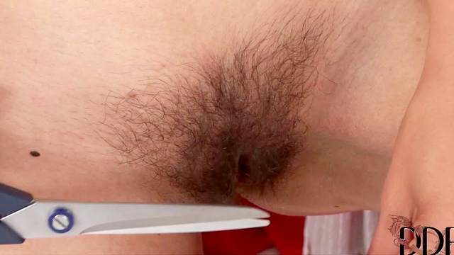 Hairy girl trims and shaves pussy