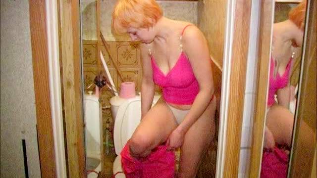 Young lady pees in the bathroom