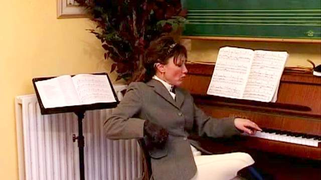 Piano teacher spanks her student hard