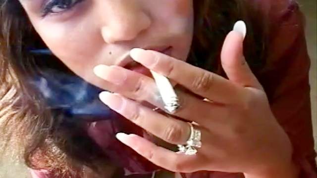 Smoking Latina sucks on a hard cock
