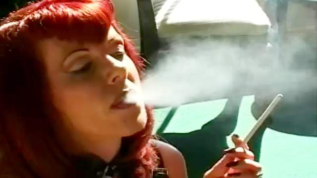 Cool redheaded milf smokes and jills her snatch