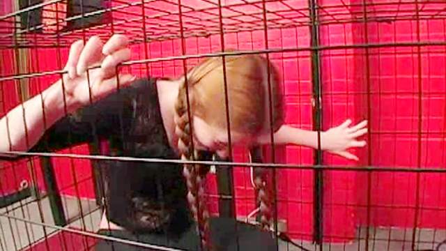 Teen redhead in pigtails caged by mistress