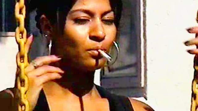 Latina smokes and catches sun outdoors