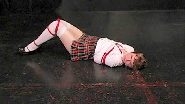 Schoolgirl bound by red ropes