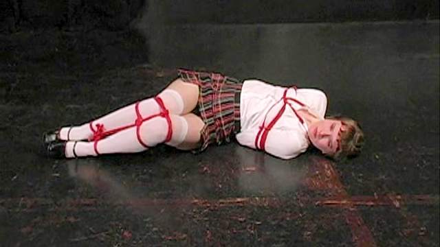 Schoolgirl bound by red ropes