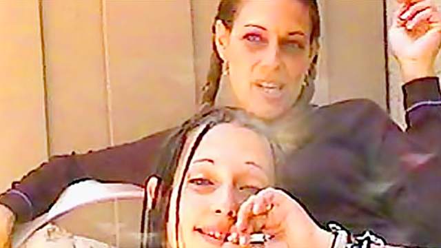 Women smoke and talk to the camera